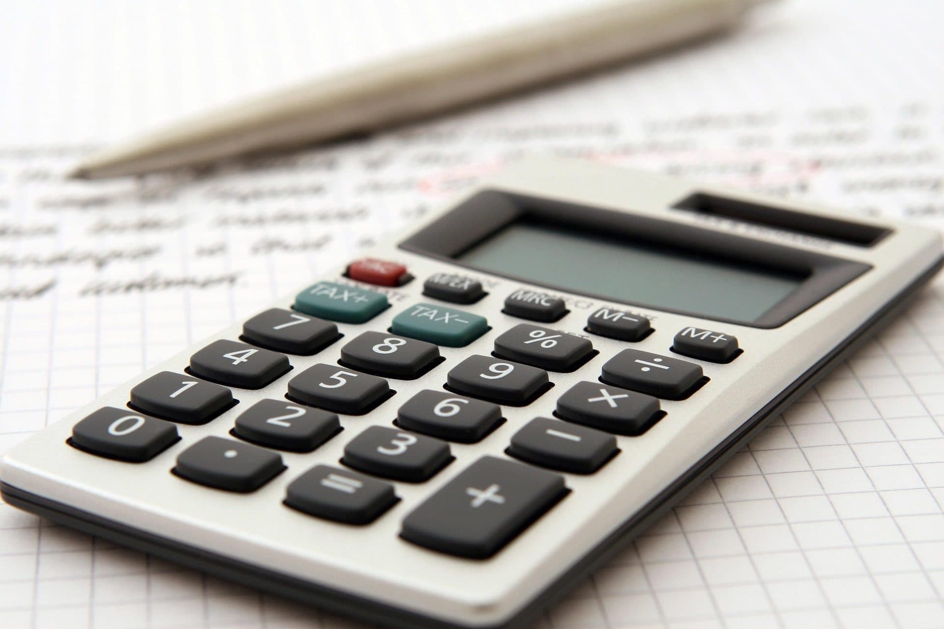 Calculator and notepad representing foundation repair cost estimating