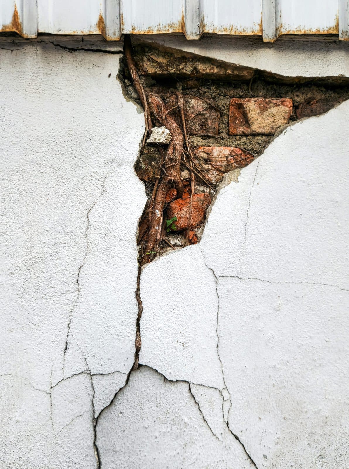 Large crack in an exterior wall caused by foundation settlement
